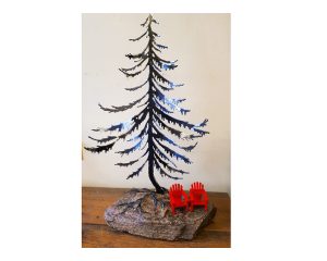 Metal sculpted spruce tree and two red chairs displayed on a rock